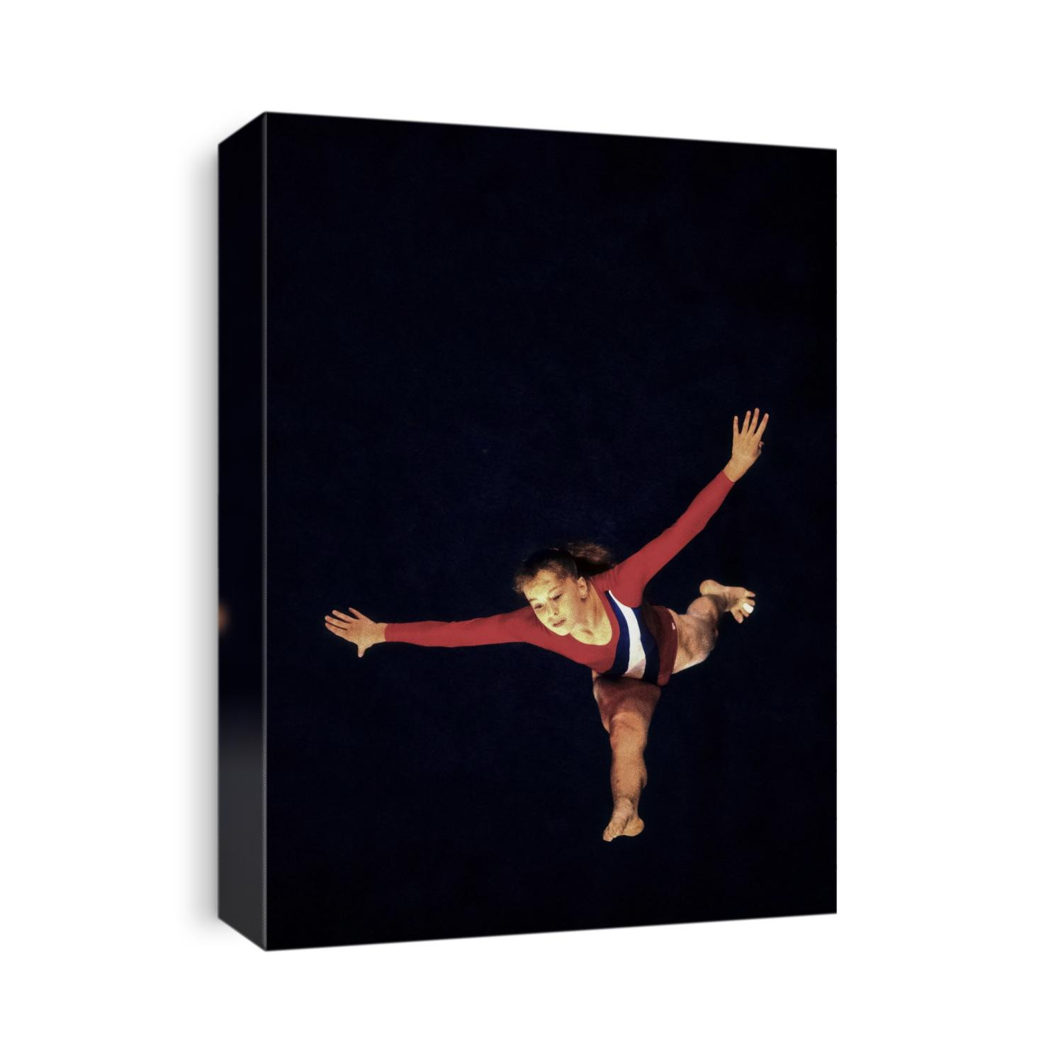 Female gymnast preforms on the floor exercise.