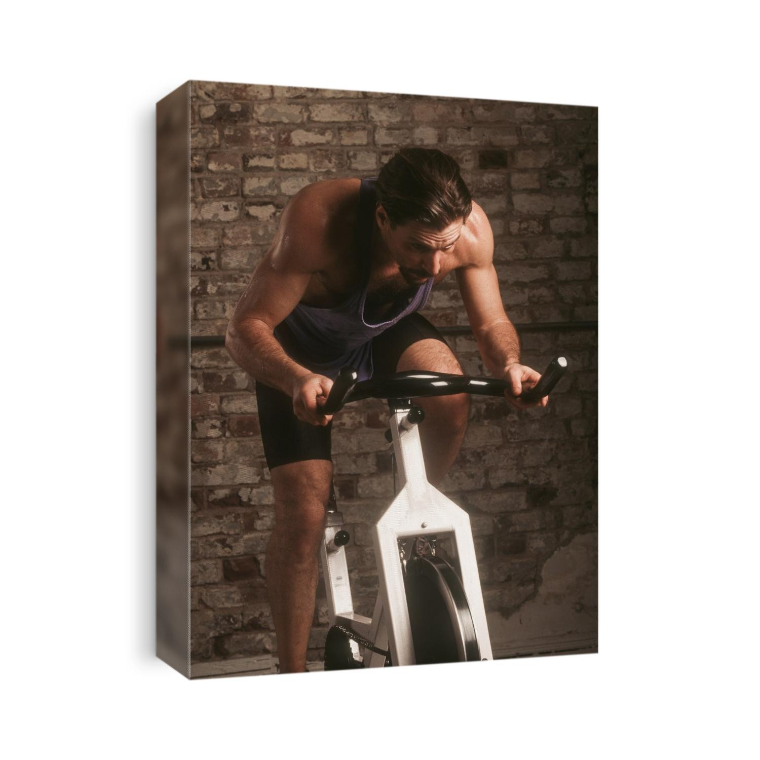 Adult male exercising on a stationary bike.