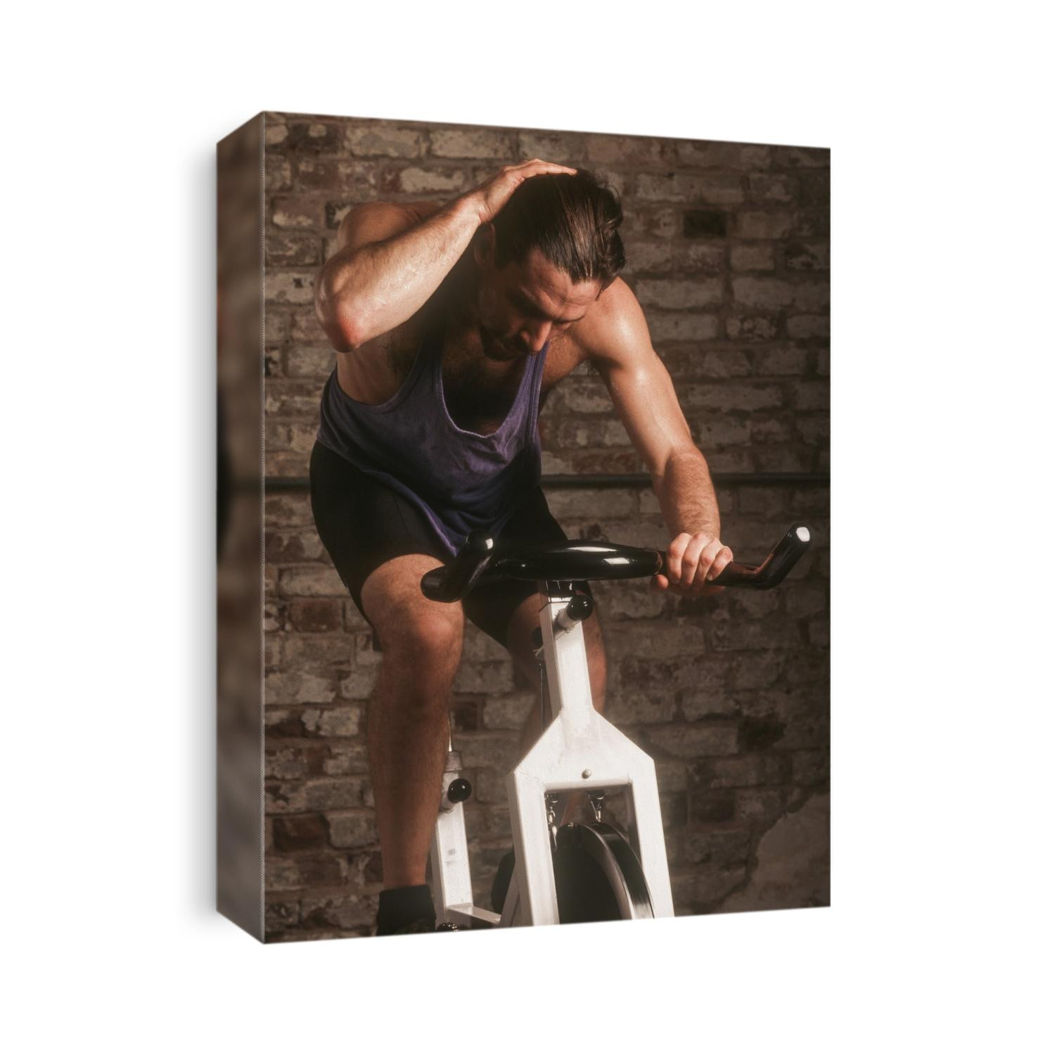 Adult male exercising on a stationary bike.