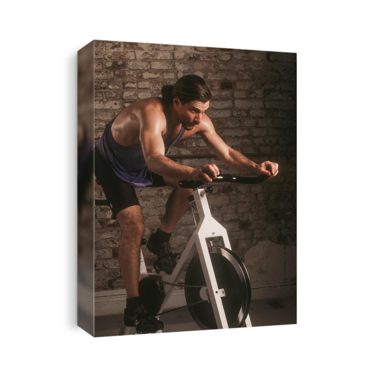 Adult male exercising on a stationary bike.