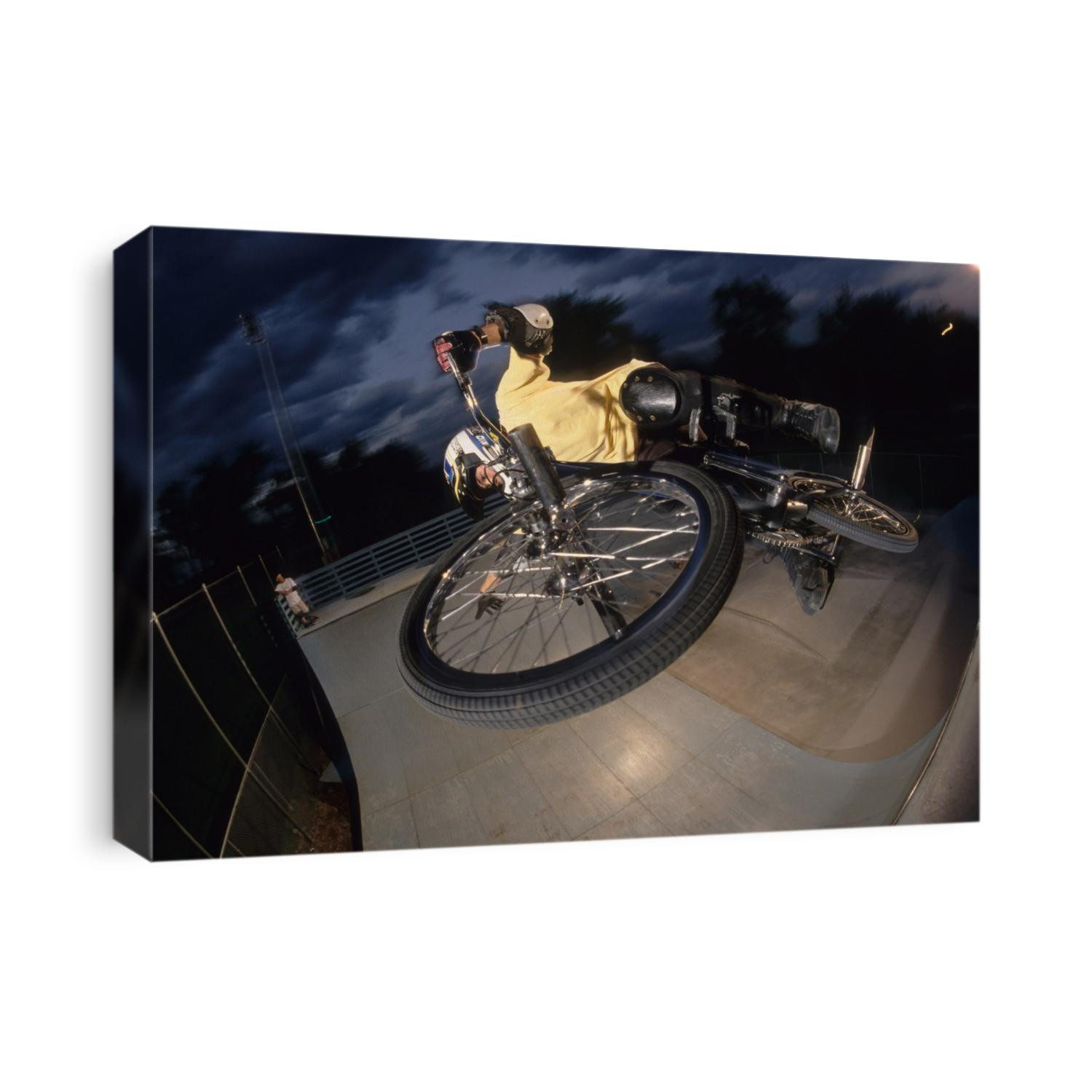 BMX cyclist flys over the vert.