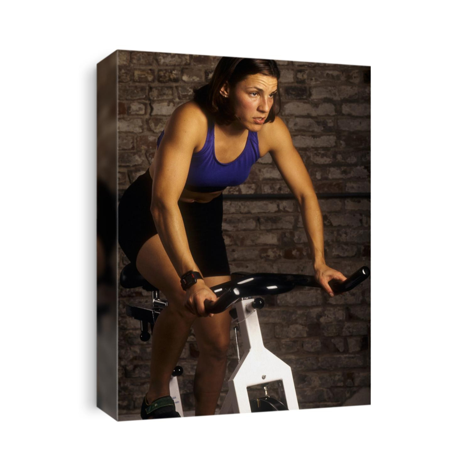 Young woman exercising on a stationary bike.