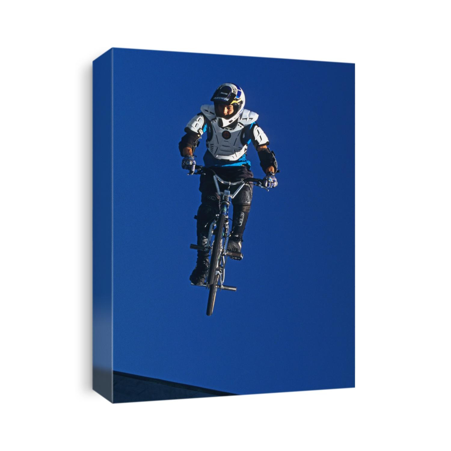 BMX cyclist flys over the vert.