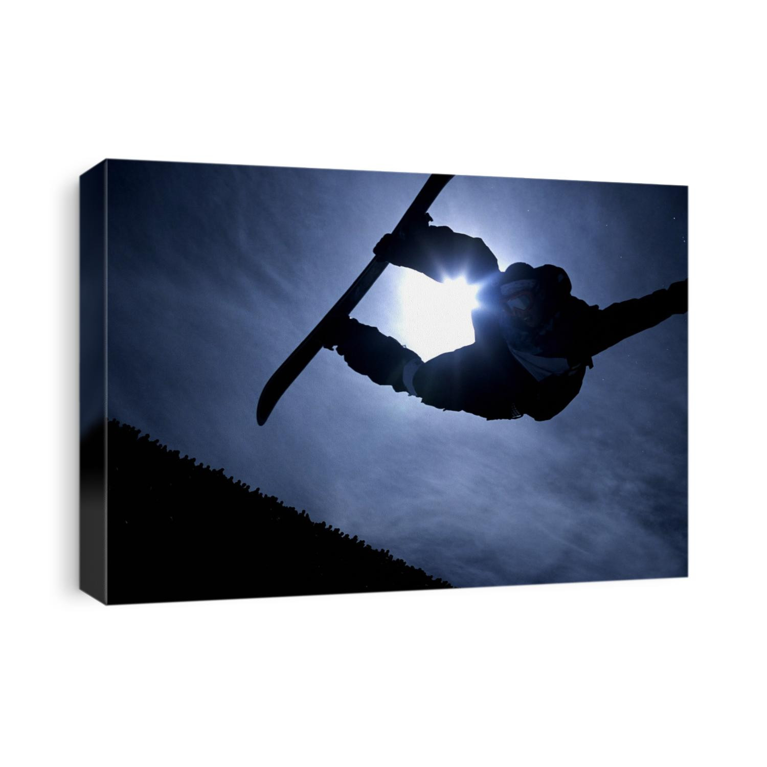 Silhouette of male snowboarder flying over the vert