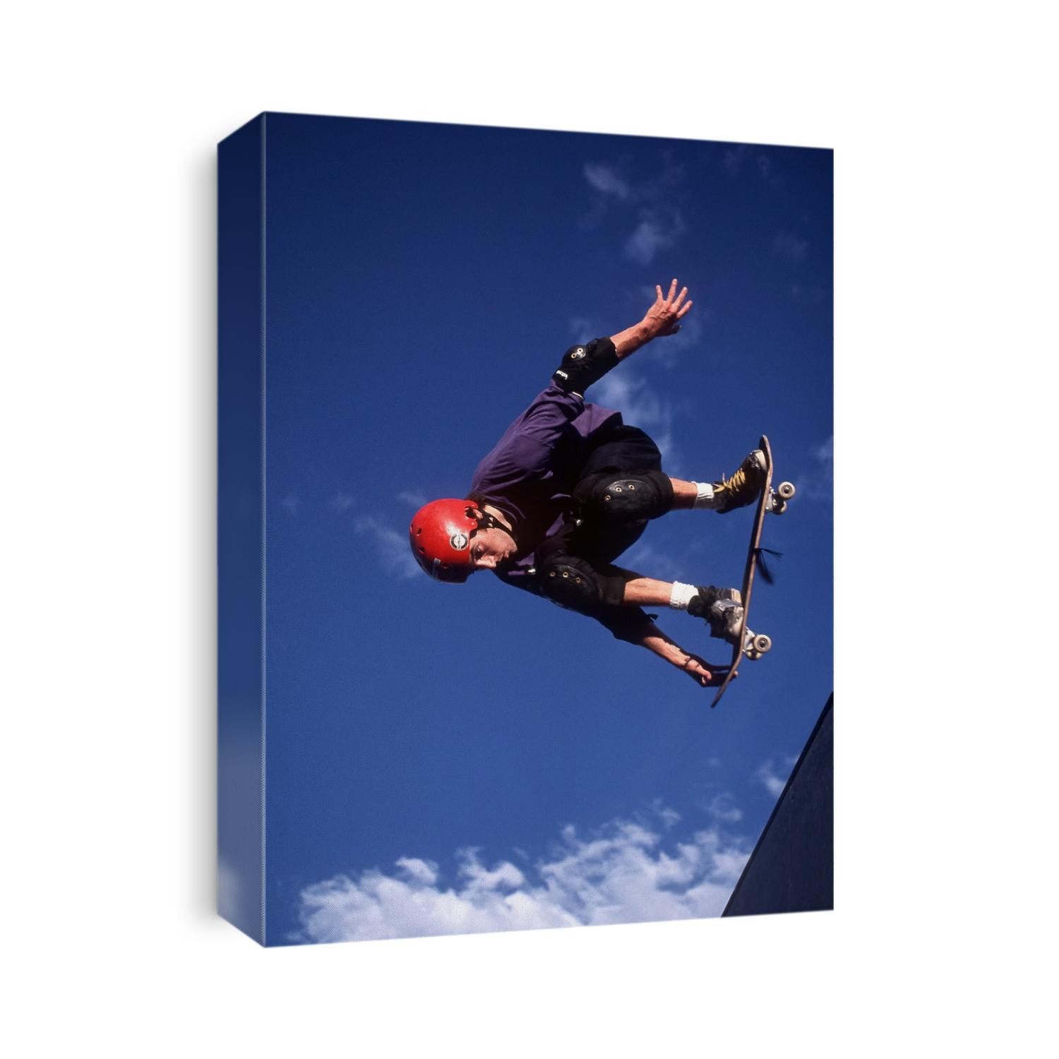 Male skaeboarder flys over the vert