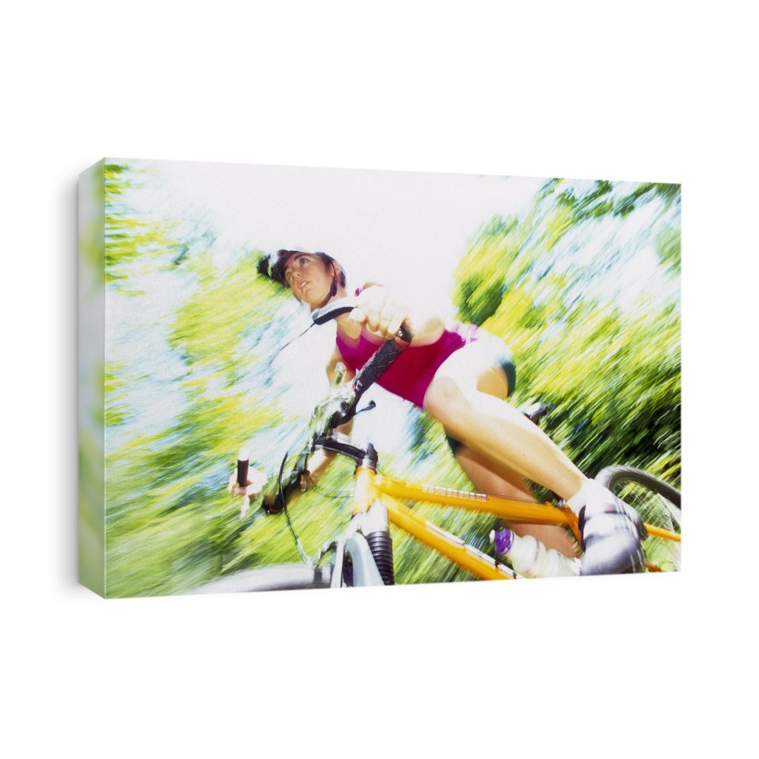 Young female recreational mountain biker riding in the forest.
