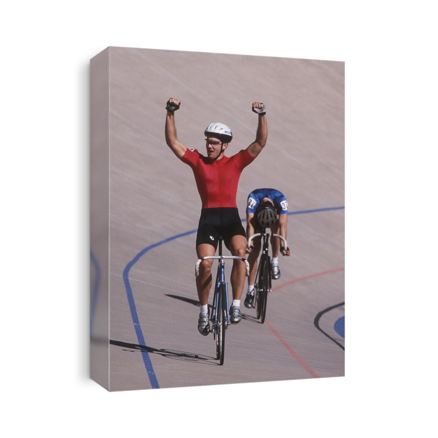 Male cyclist winning on the velodrome.