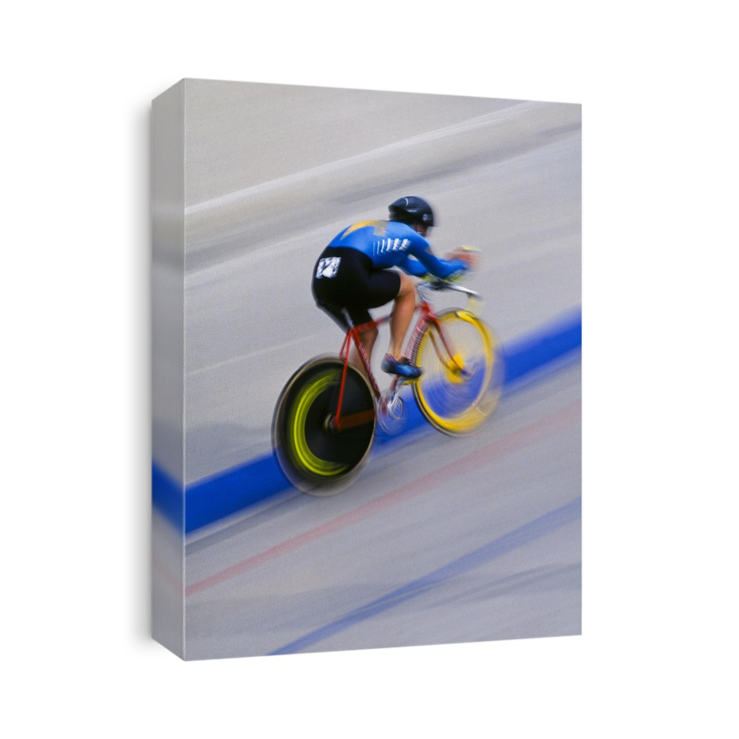 Femalre cyclist racing on the velodrome track.