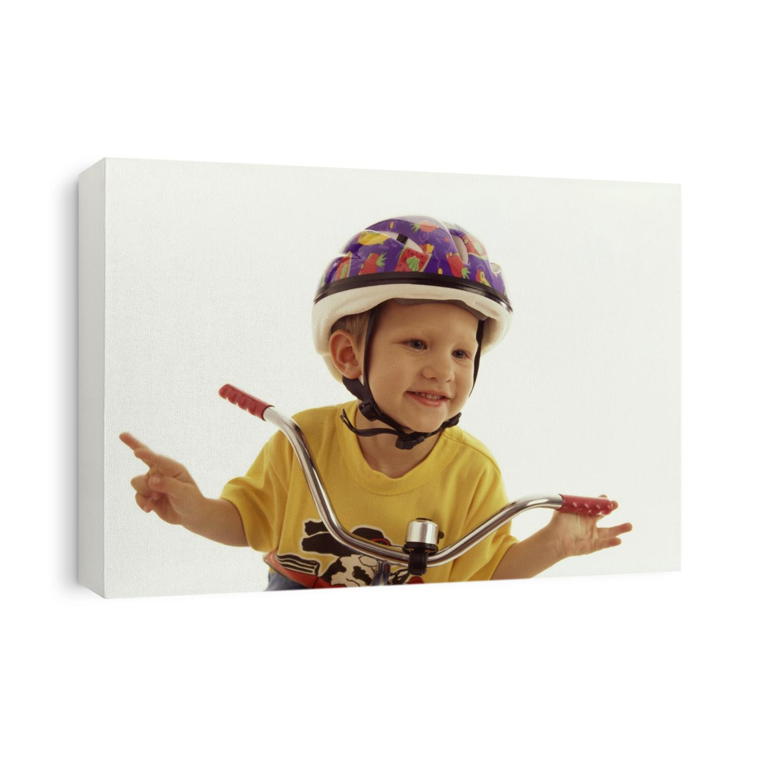 4 year old boy posing on his tricycle.