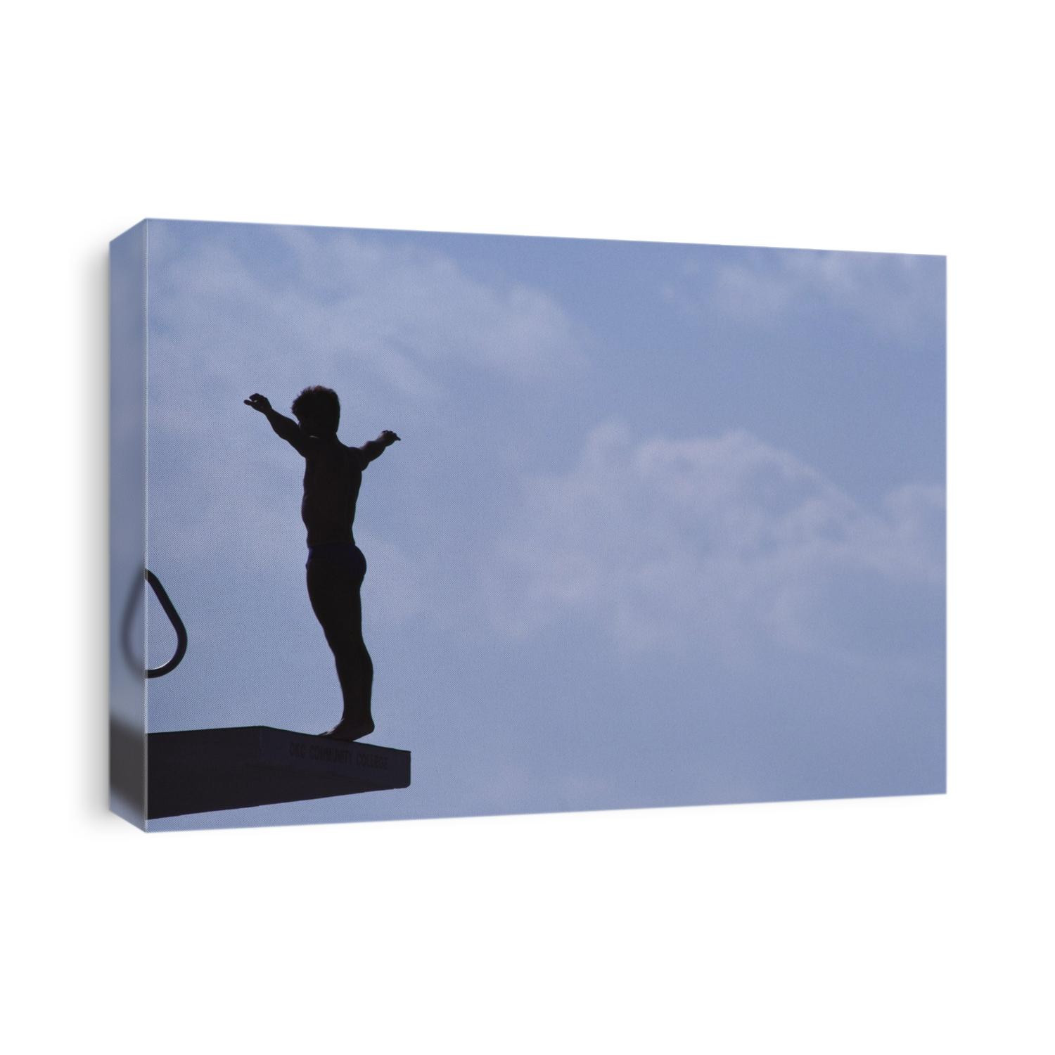 Silhouette of male diver on platform.