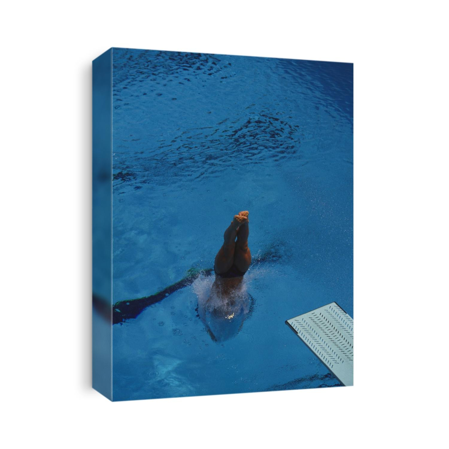 Female diver splashes through the surface of the water.