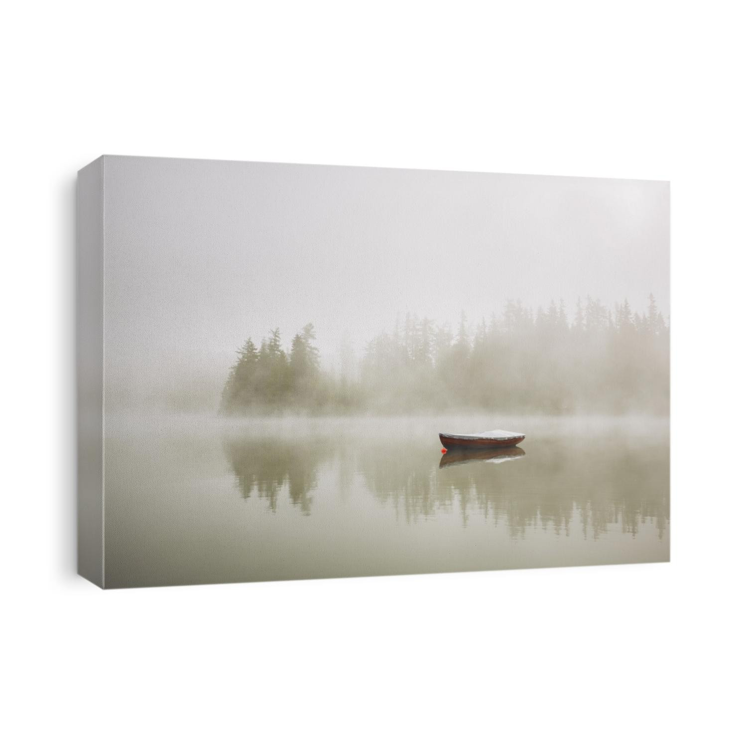 Boat on the lake at morning fog.