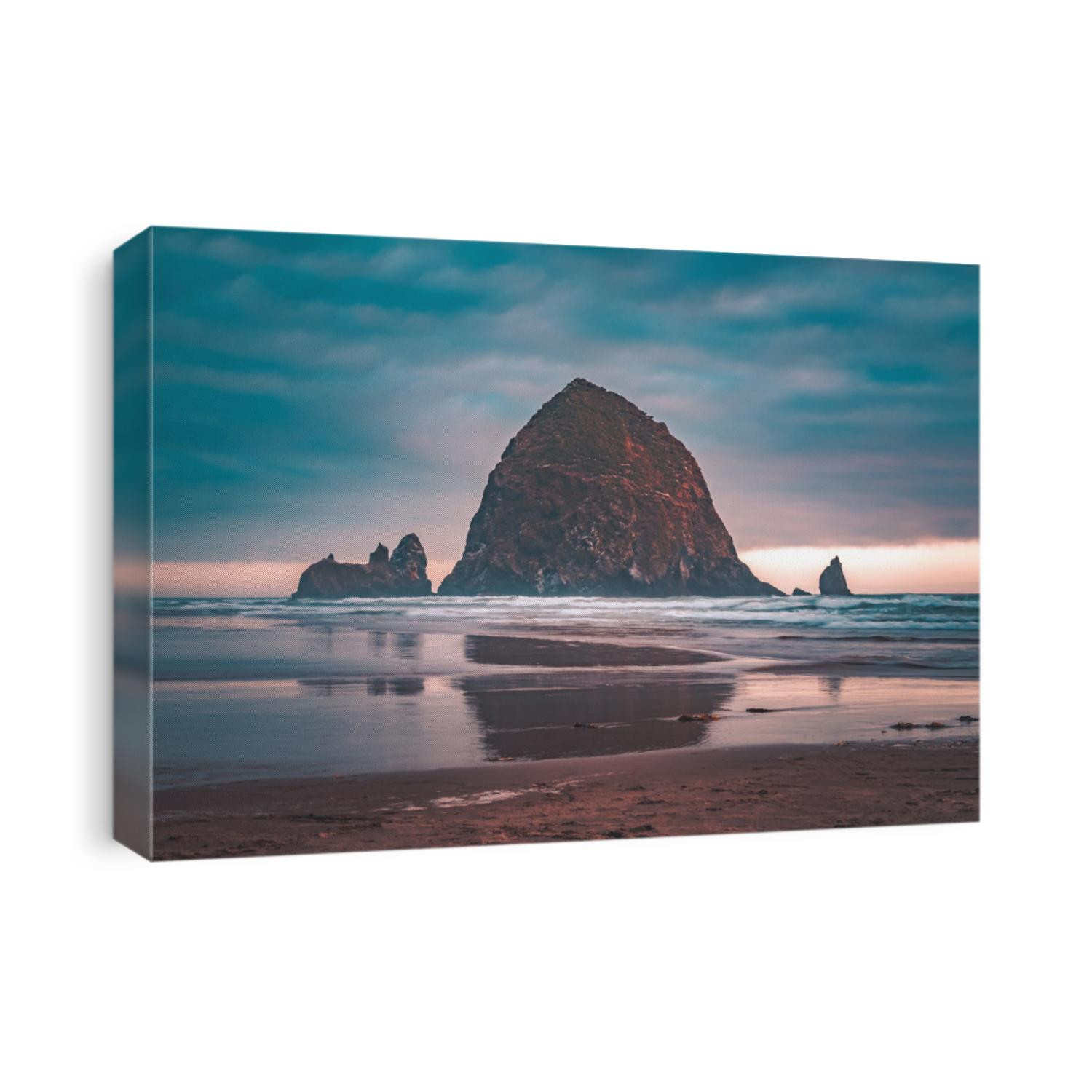 Summer sunset at Haystack Rock, an iconic monolithic rock at Cannon Beach in Clatsop County, Oregon, USA.  