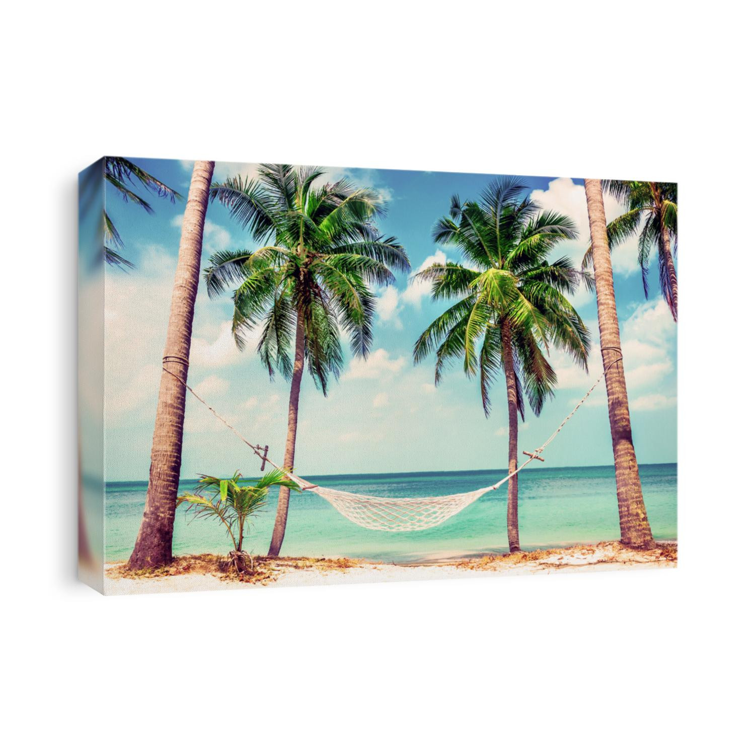 Beautiful beach. Hammock between two palm trees on the beach. Holiday and vacation concept