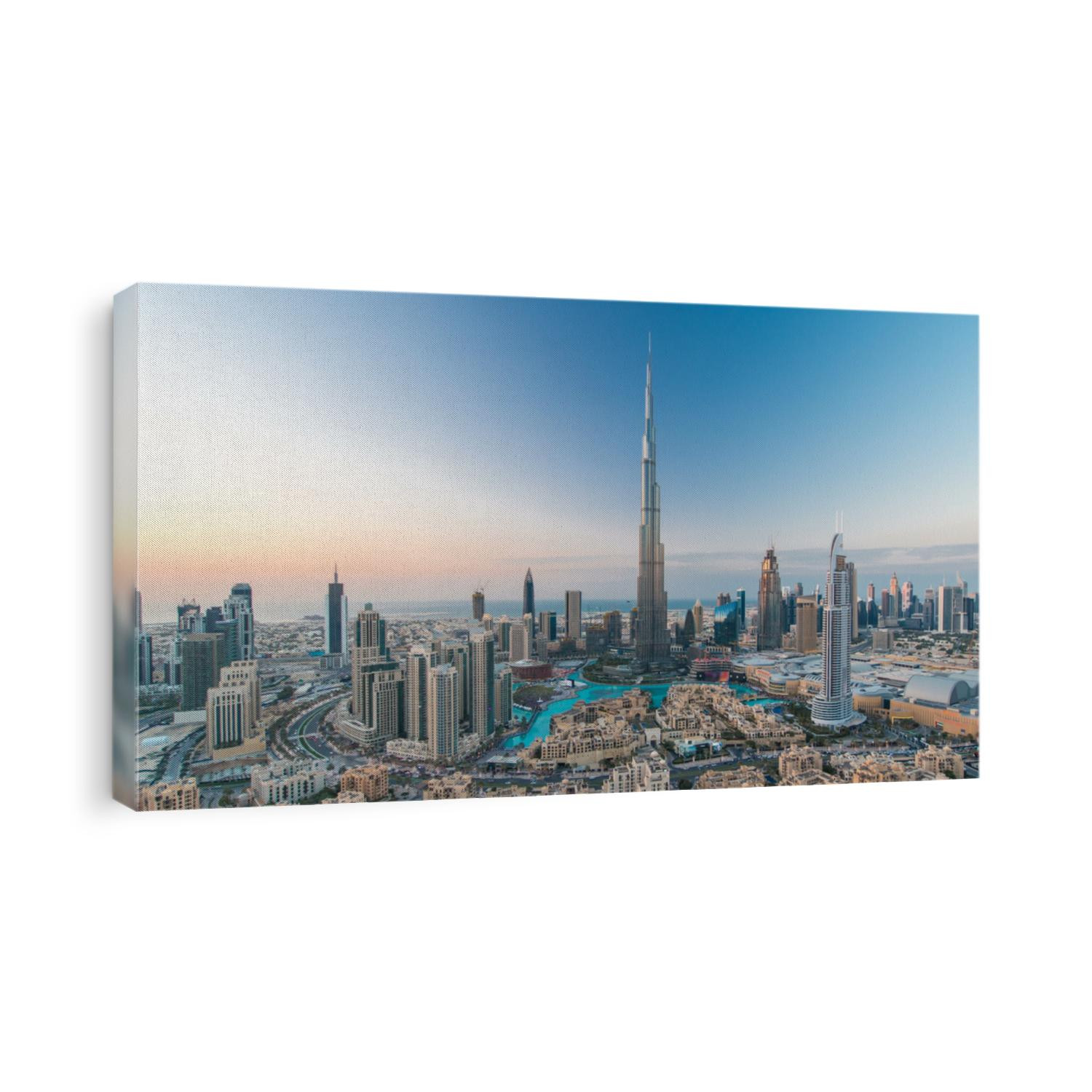 Dubai Downtown day to night transition timelapse with Burj Khalifa and other towers view from the top before new year celebration in Dubai, United Arab Emirates. Lights turning on. Pan right