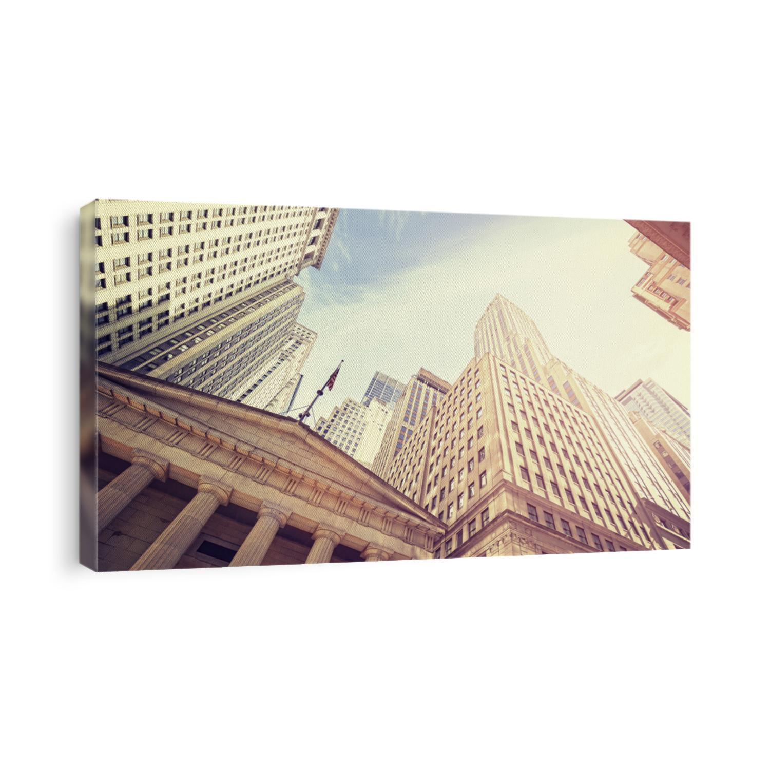 Vintage toned Wall Street at sunset, Manhattan, New York City, USA.