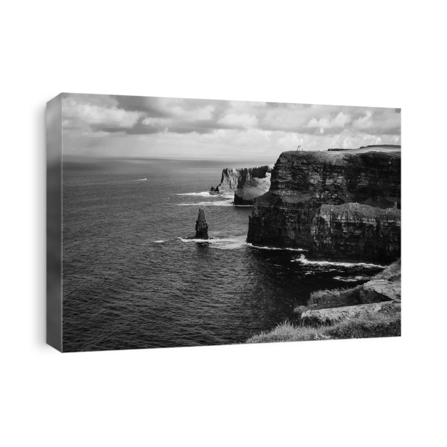 Black and white photo of the famous cliffs of Moher in County Clare, Irealand - taken on a sunny summer day with the Atlantic ocean in the distance.