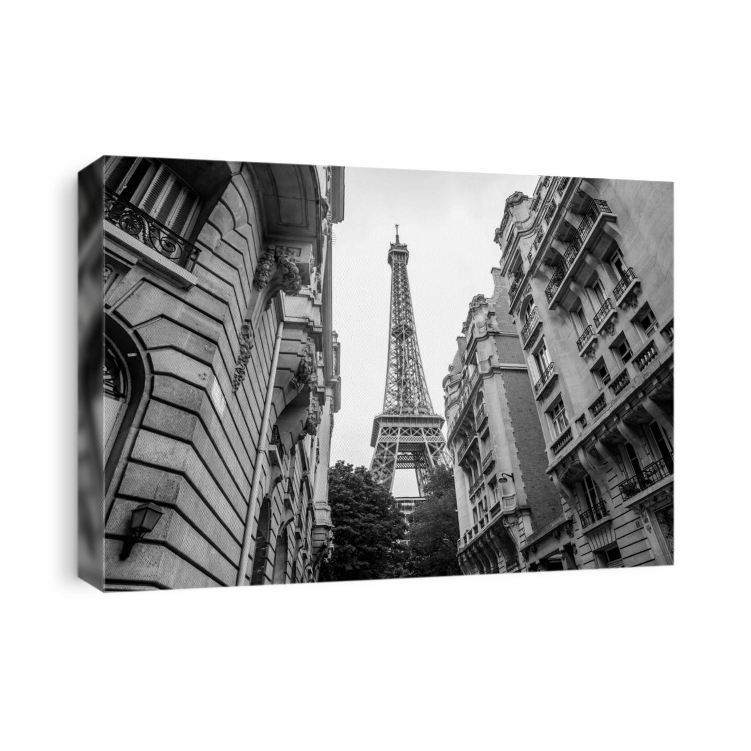 Small paris street with view on the famous Eiffel tower on a cloudy rainy day in black and white
