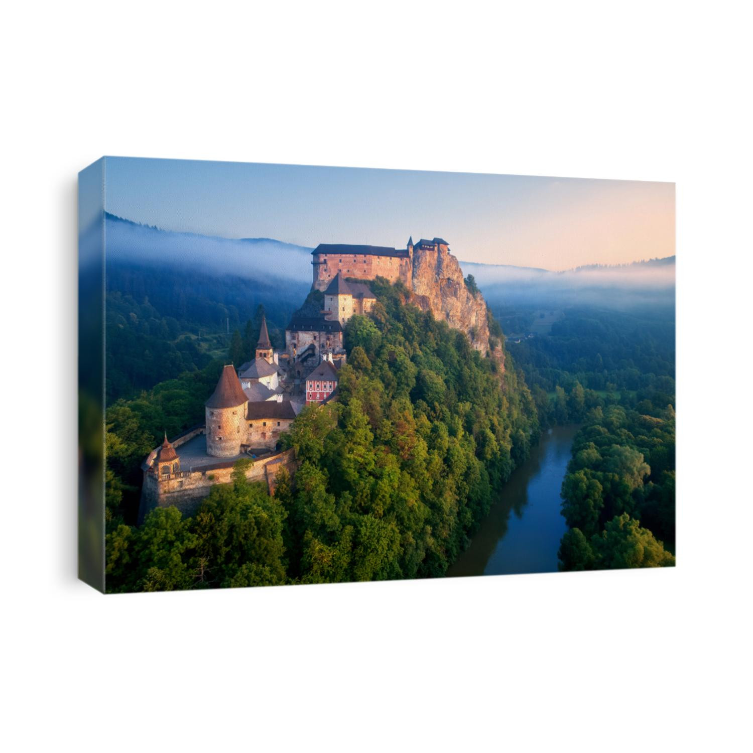 Panoramic, aerial view of Orava Castle, fantasy castle situated on a high rock above Orava river, illuminated by rising sun, surrounded by deep forest and foggy mountains. Castles of Slovakia.