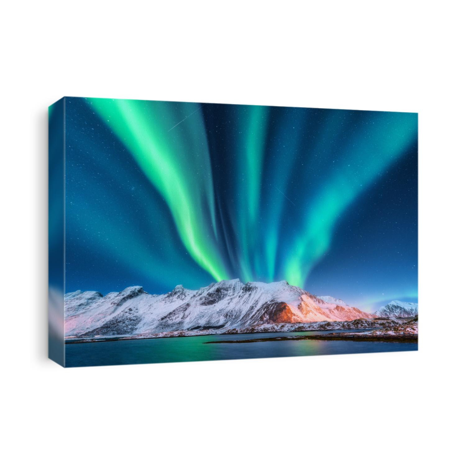 Aurora borealis. Lofoten islands, Norway. Aurora. Green northern lights. Starry sky with polar lights. Night winter landscape with aurora, sea with sky reflection and snowy mountains.Nature background