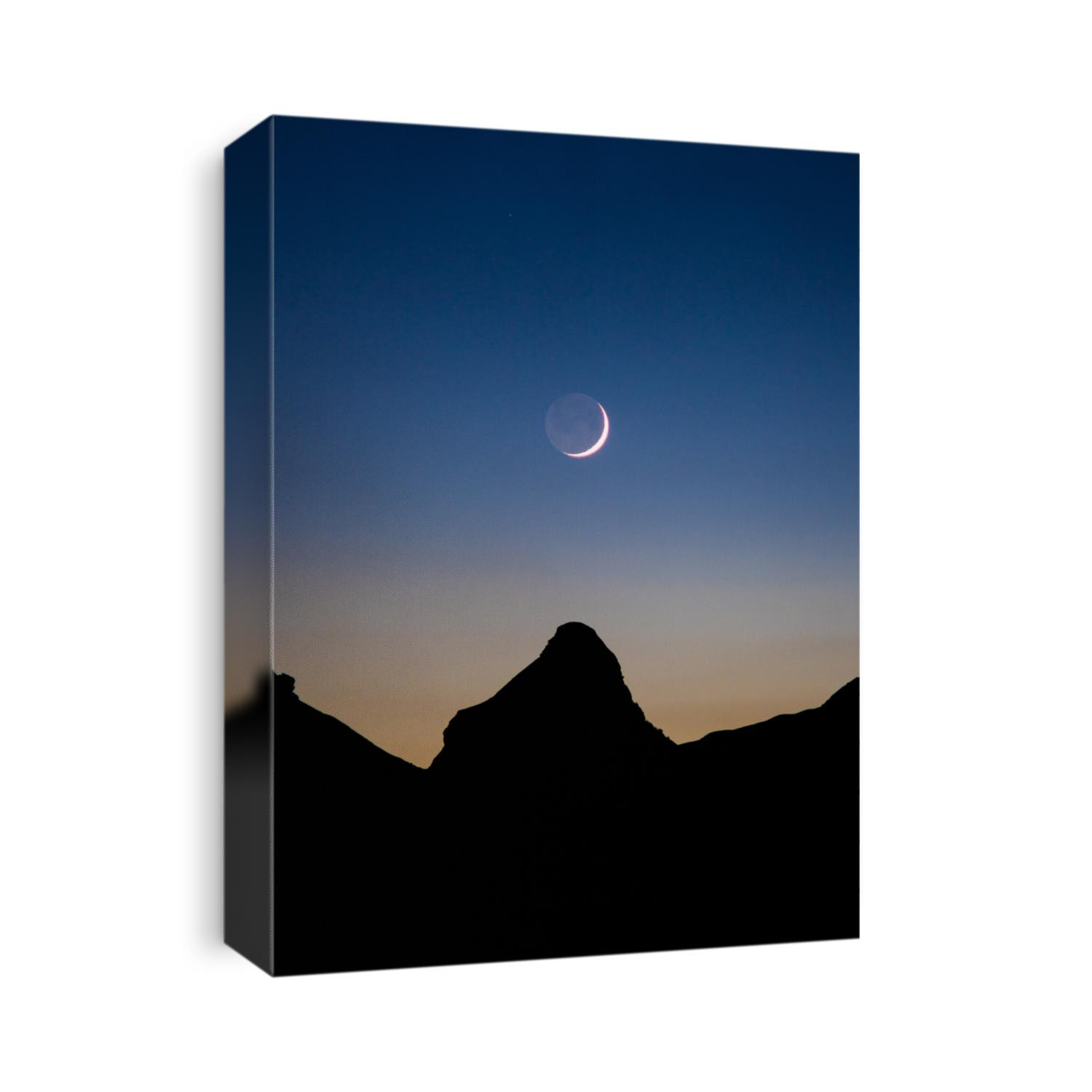 Waning crescent Moon above Mountain sharp peak