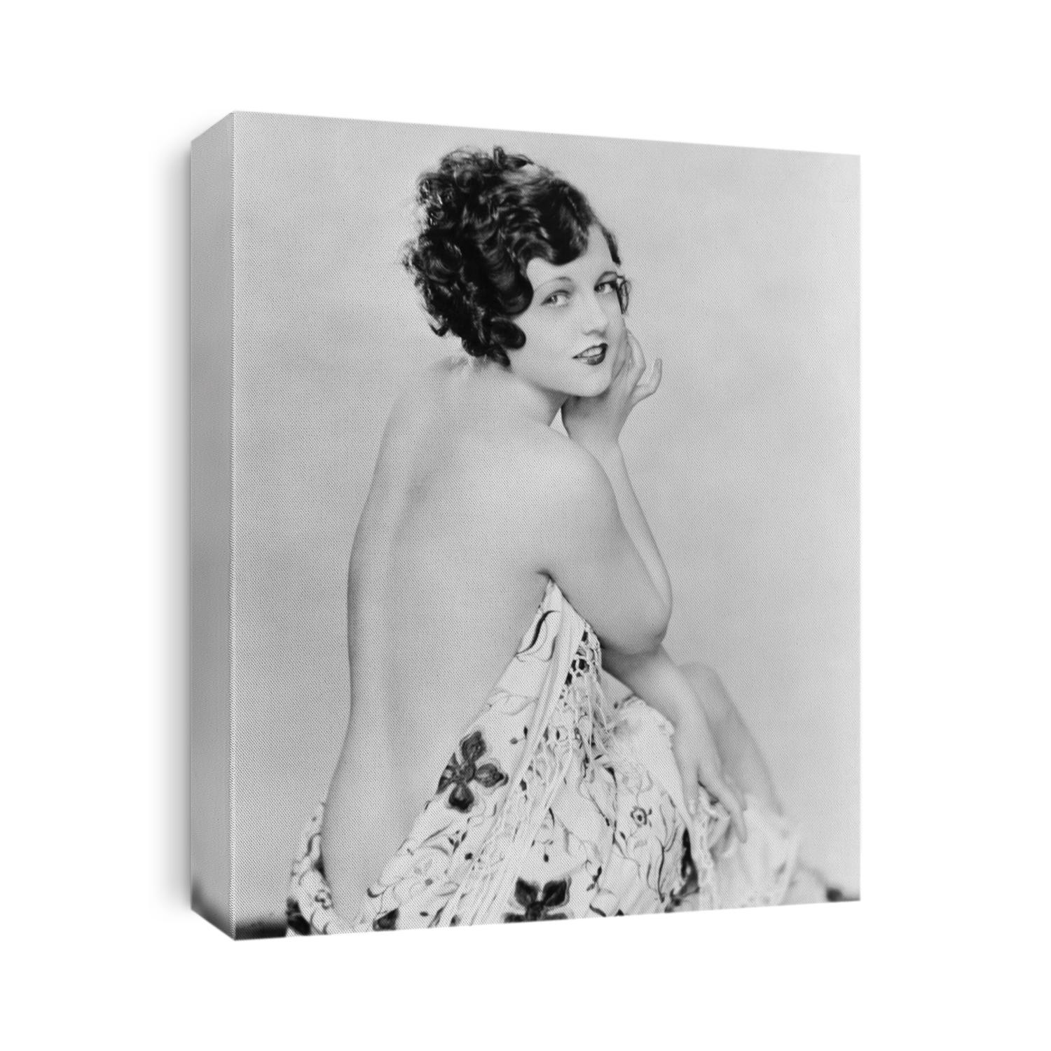 Portrait of a nude young woman draped in a sheet