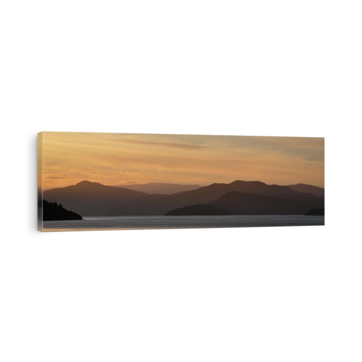 Wide panorama of Sunset, mountains and ocean around Cook Strait approaching Picton, New Zealand South Island