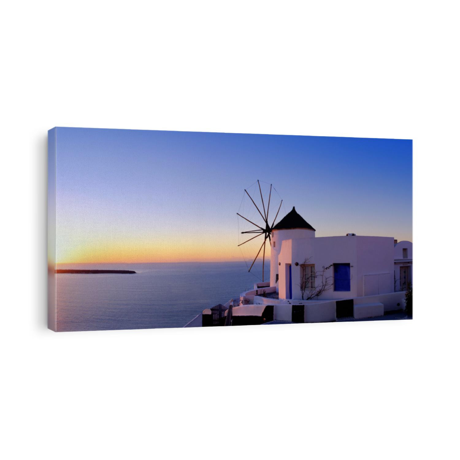 Windmill in Oia village on Santorini, Greece, at sunset