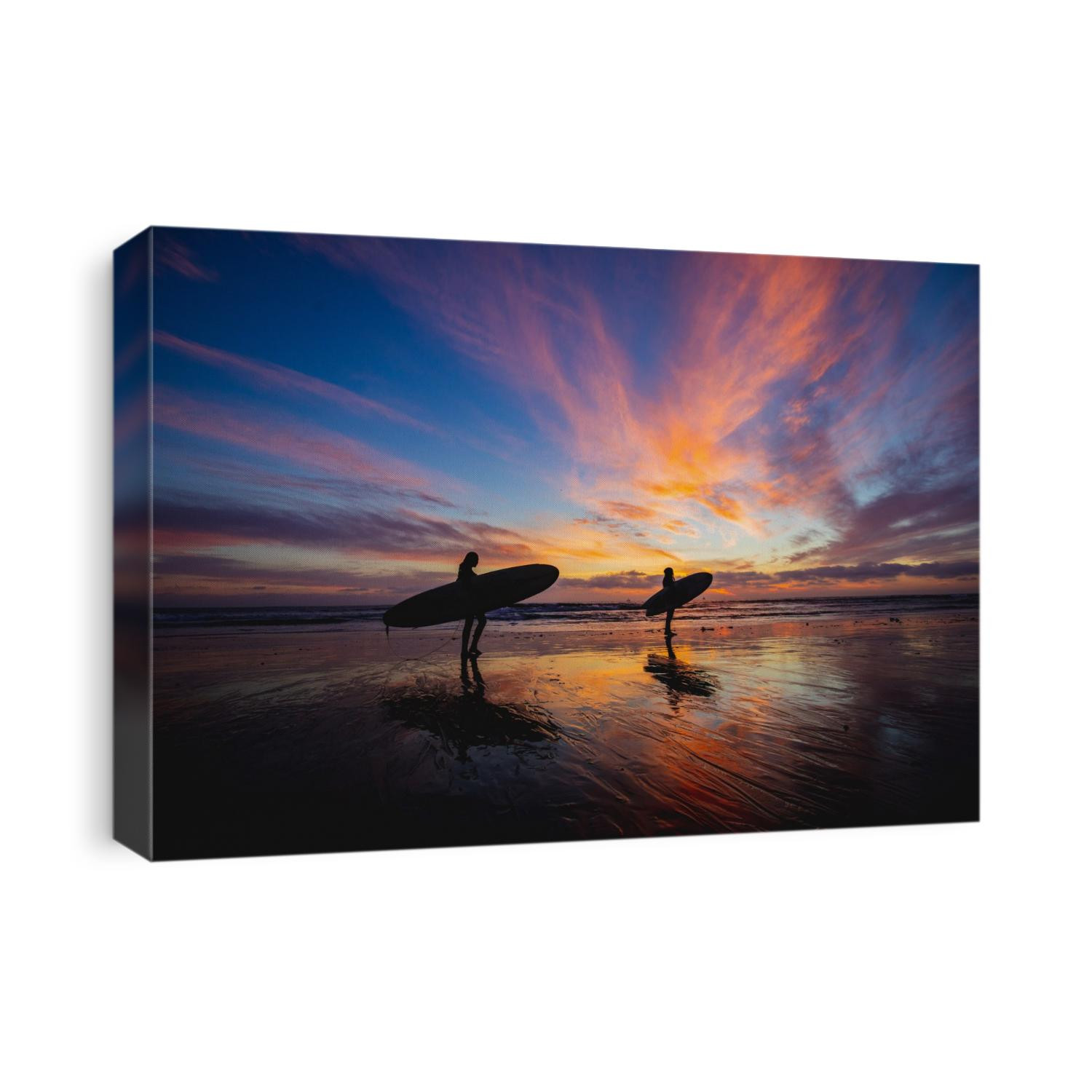 Two surfers silhouetted against a California sunset